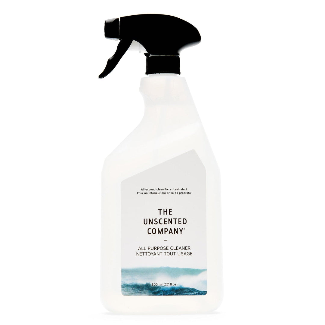 Clear spray bottle with black nozzle labeled 'The Unscented Company' on a white background